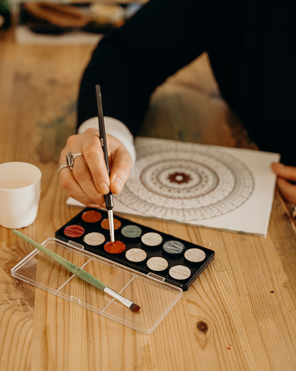 Woman painting a mandala for the MARI assessment in Rochester, NY